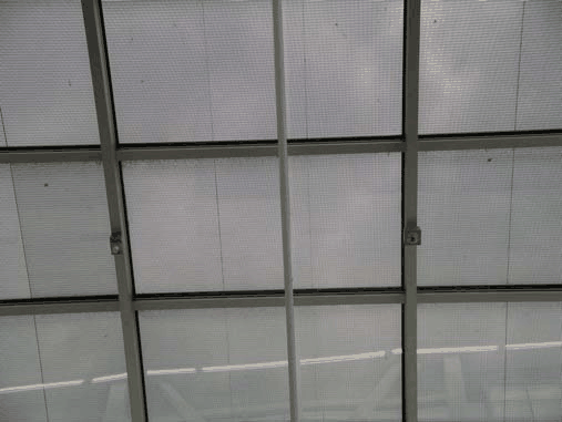 Thin-film PV glazing in the vestibule roof shades direct sunlight while allowing daylight to filter into the space