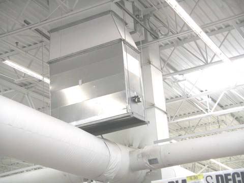 Fabric duct (ductsox) and rooftop unit supply connection above the sales floor